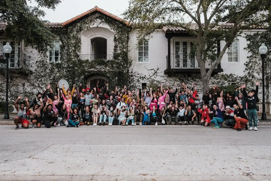 Group of diverse people happily posing in front of a historic house, Orlando, FL.