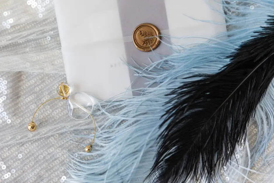 A sophisticated wedding invitation surrounded by gold accents, feathers, and sequins, perfect for luxury events.
