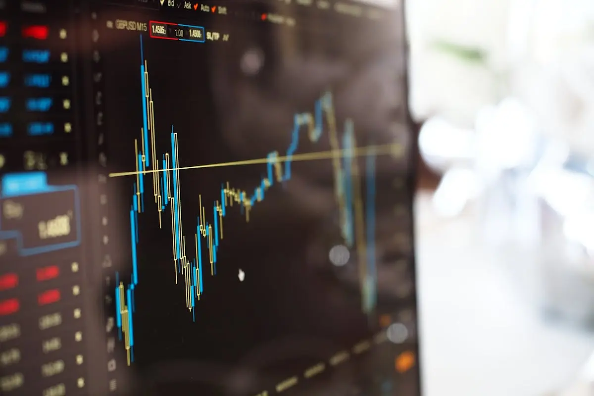 Detailed view of financial trading graphs on a monitor, illustrating stock market trends.