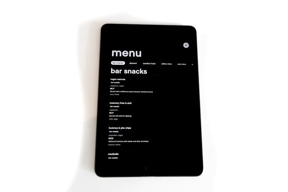 Tablet displaying a digital menu for bar snacks in a modern, minimalistic style.