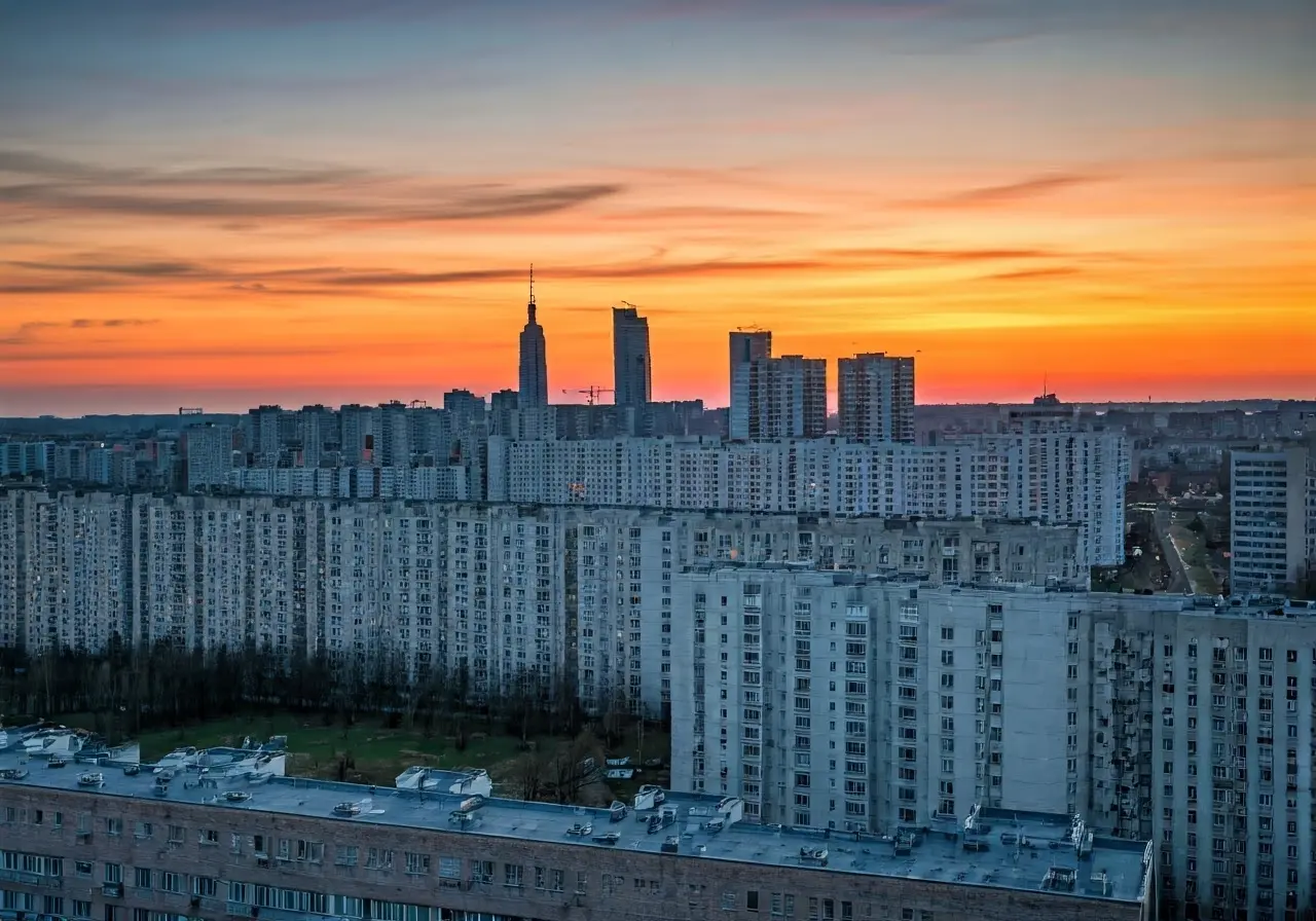 A city skyline with diverse residential buildings at sunset. 35mm stock photo
