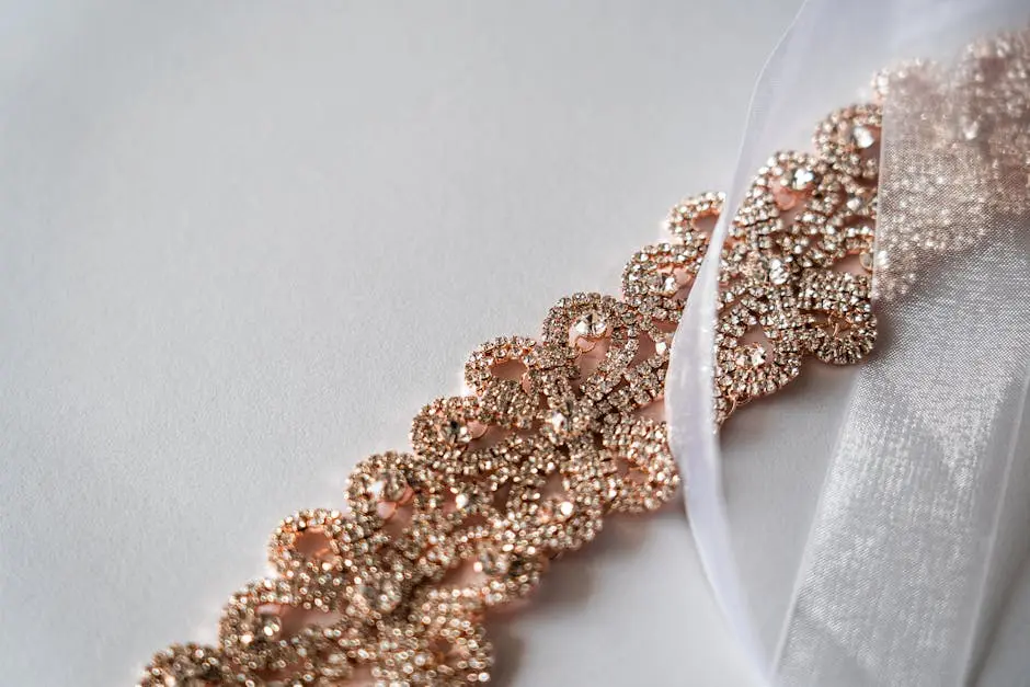 Elegant rose gold bridal necklace with sparkling diamonds on white sheer fabric, perfect for wedding accessories.