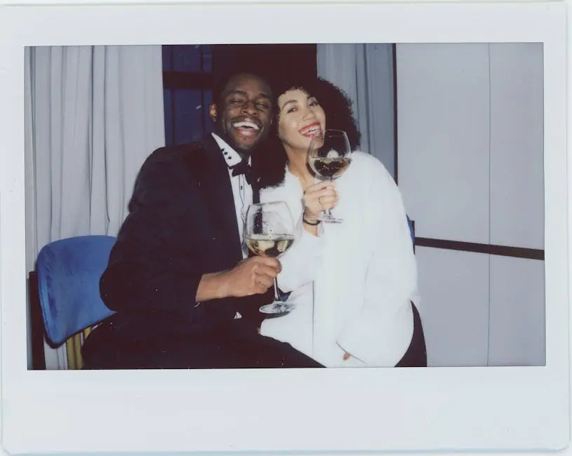 Happy interracial couple enjoying a romantic evening with wine indoors.
