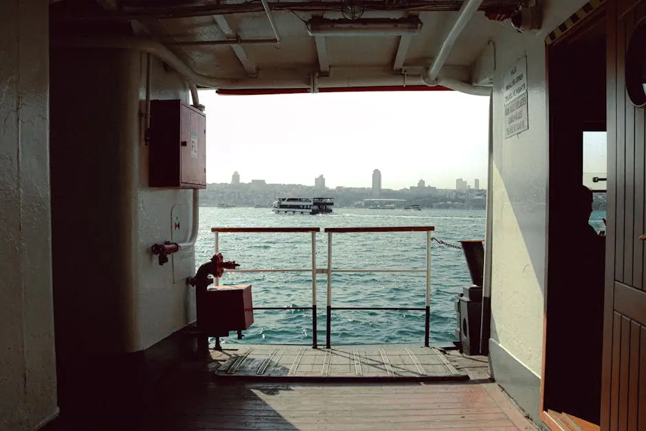 View of city skyline from inside a ferry, showcasing marine travel.