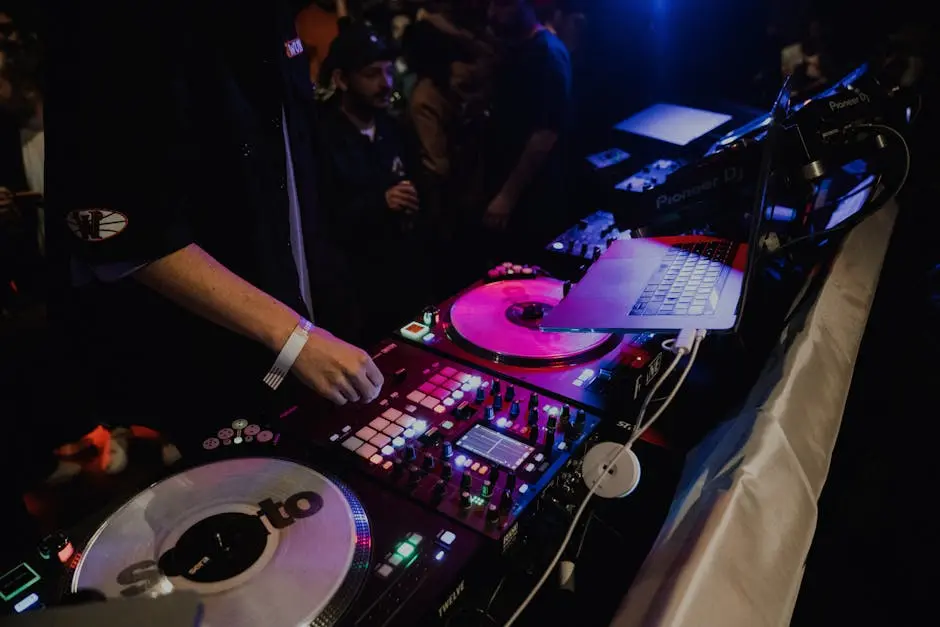 DJ mixing tracks at nightclub with vibrant lighting and crowd. Energetic nightlife scene.