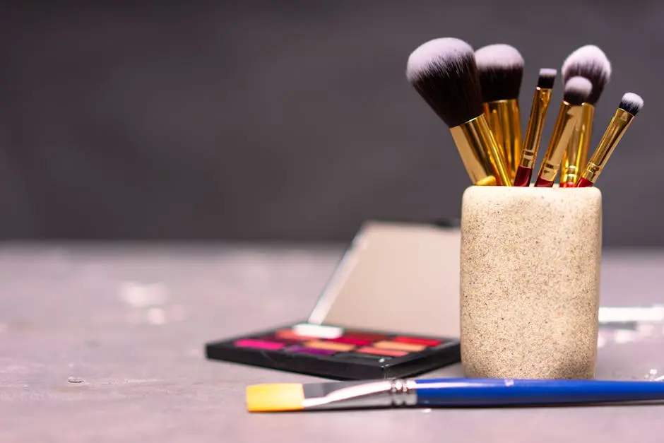 A stylish display of makeup brushes in a holder alongside a colorful palette.