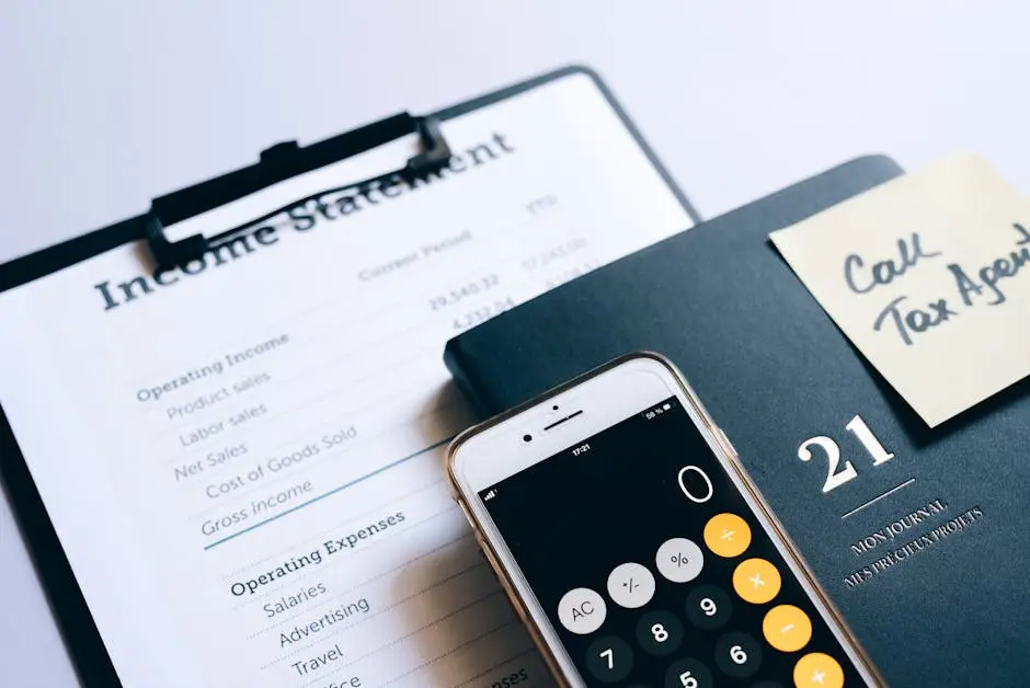 Close-up of income statement, calculator, and planner for financial planning.