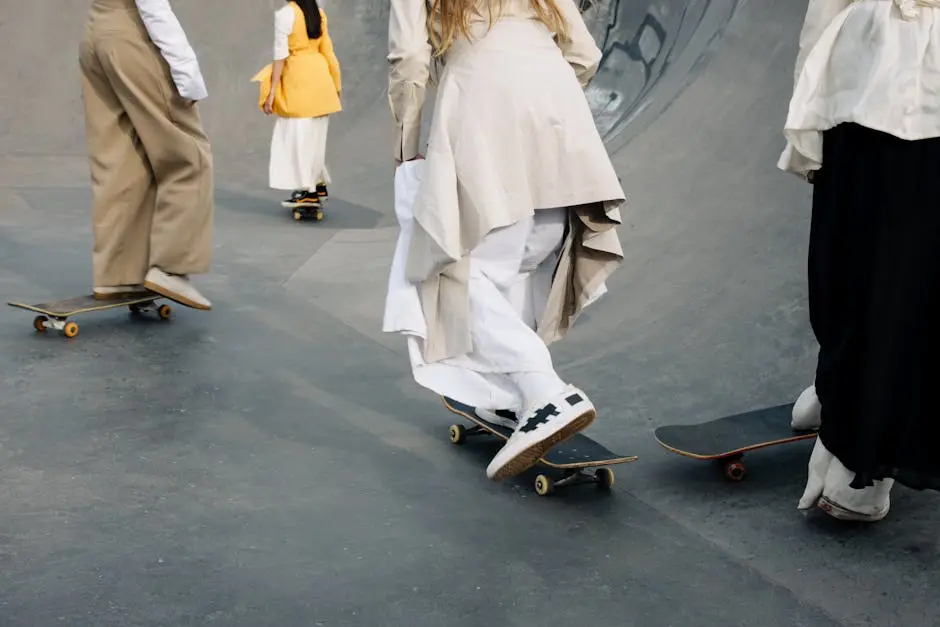 A group of individuals skateboarding in a skate park wearing fashionable, flowy attire.