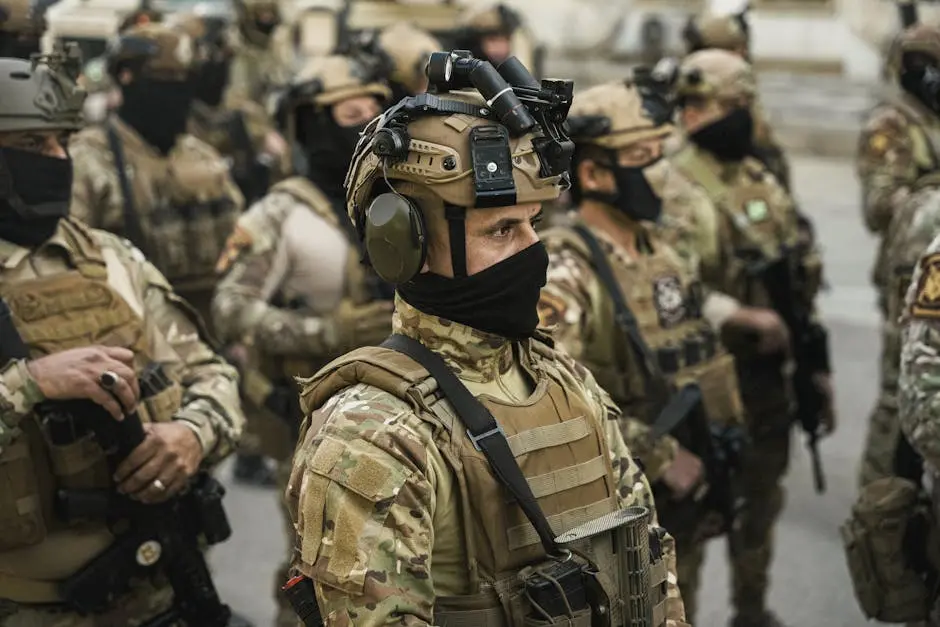 Group of soldiers in tactical gear standing in formation during a military operation.