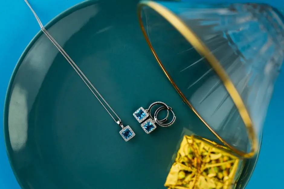 Stunning silver jewelry with blue gemstones displayed on a turquoise plate with a glass accent.