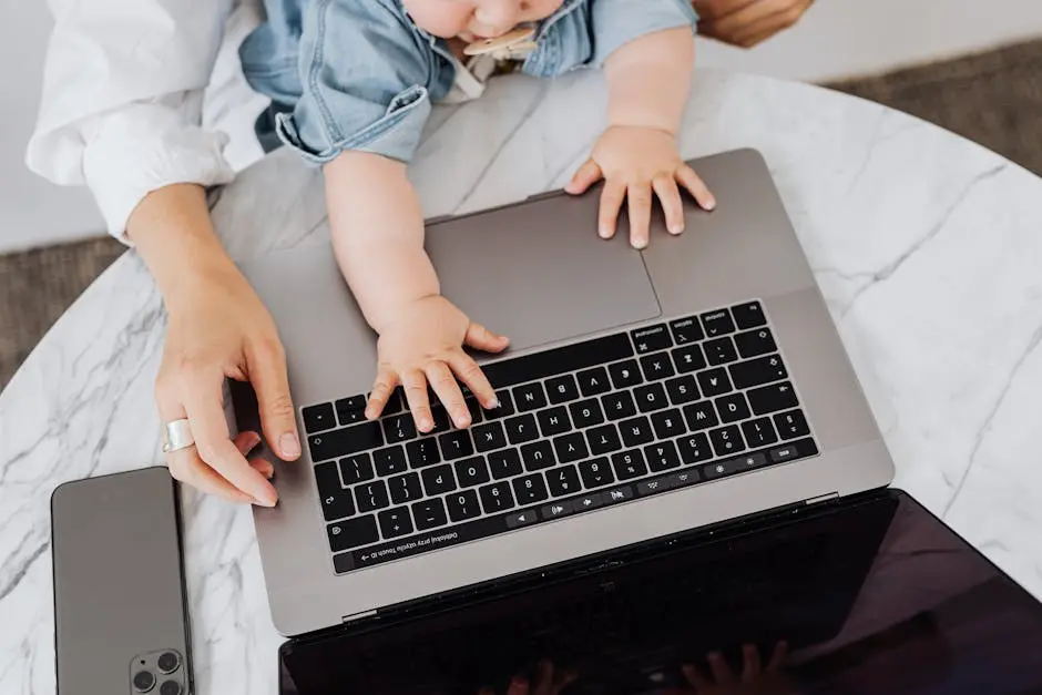 Top view of a parent and a child’s hands on a laptop keyboard, symbolizing digital learning.