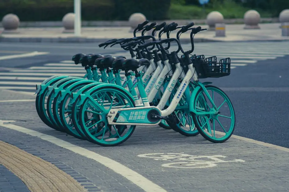 A line of rental bicycles parked on a city street, ideal for urban transportation and recreation.