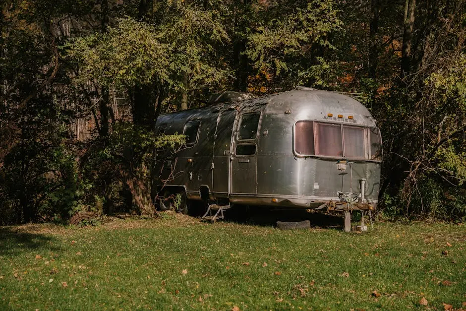 Old fashioned motor house stopped in green forest for people having rest at weekend
