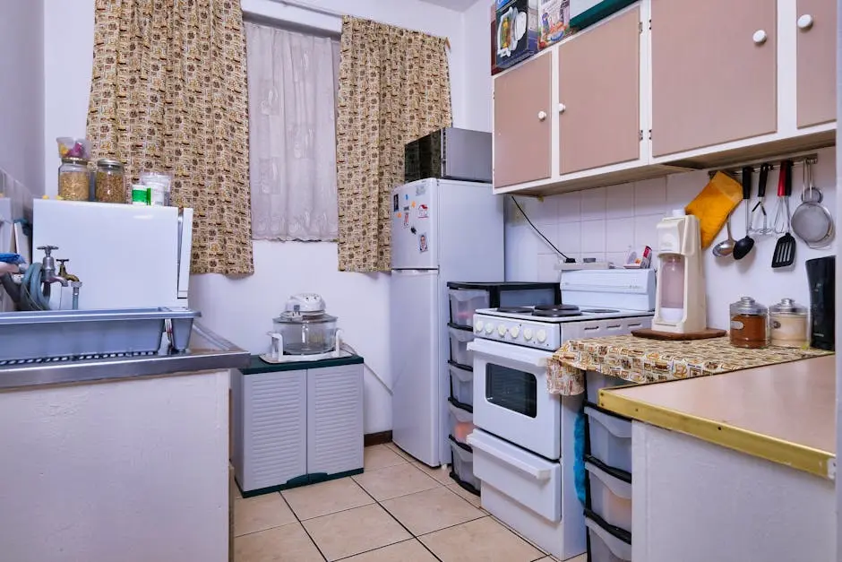 A compact kitchen featuring modern appliances and cozy design elements, perfect for small homes.