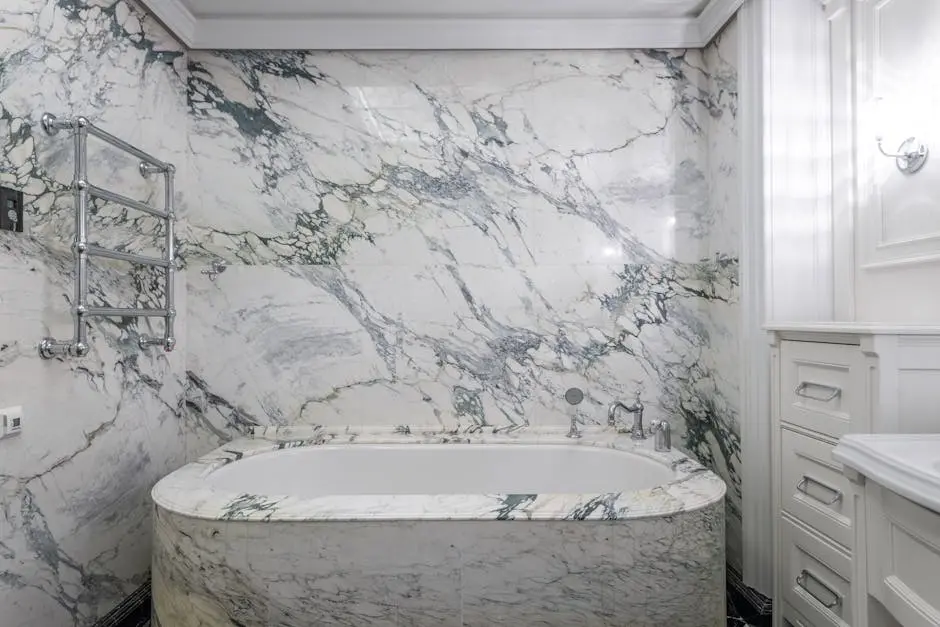 Luxurious modern bathroom with marble tub and wall, featuring elegant design elements.