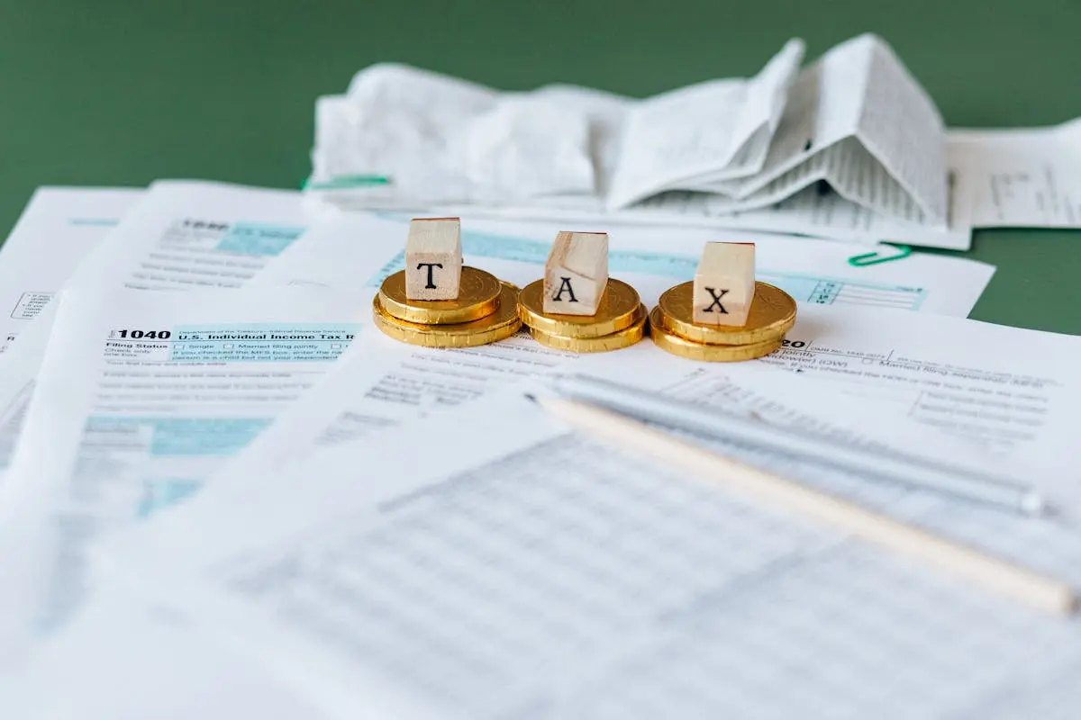 Close-up of tax forms, receipts, and coins symbolizing business acquisitions