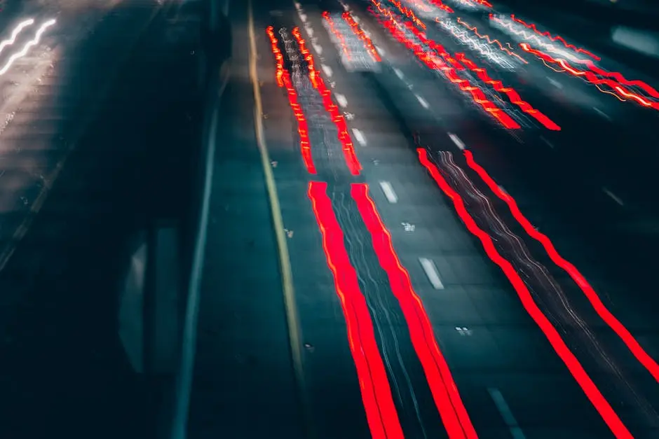 Long exposure of blurred night traffic in Los Angeles, showcasing light trails on a busy city highway.