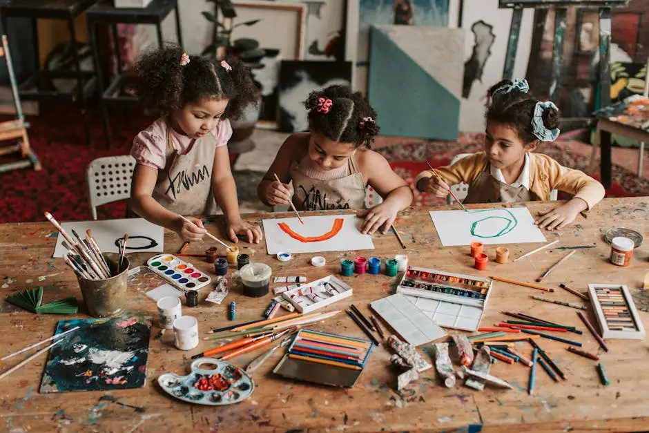 Three young girls engaged in a vibrant painting session at an art studio.