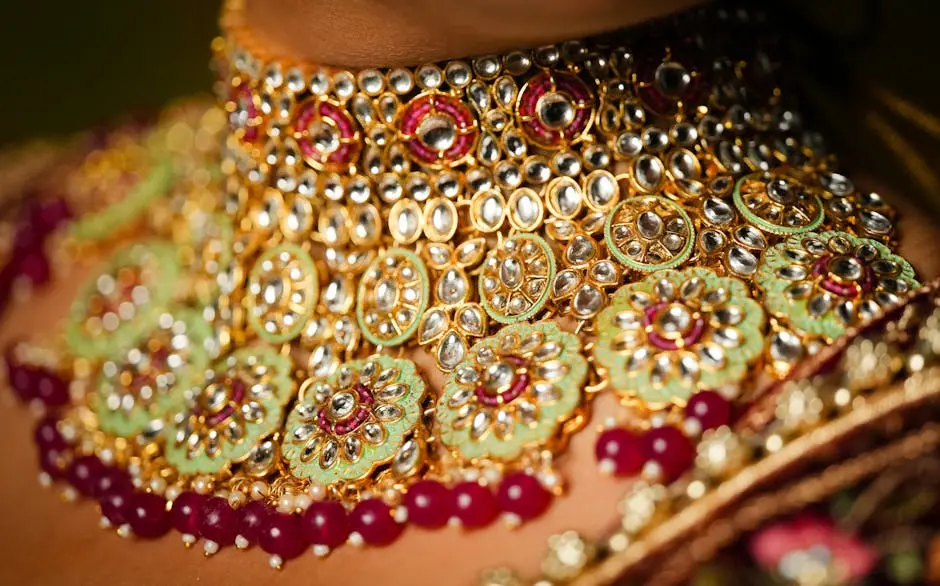Close-up of ornate traditional gold and gemstone necklace highlighting intricate craftsmanship.