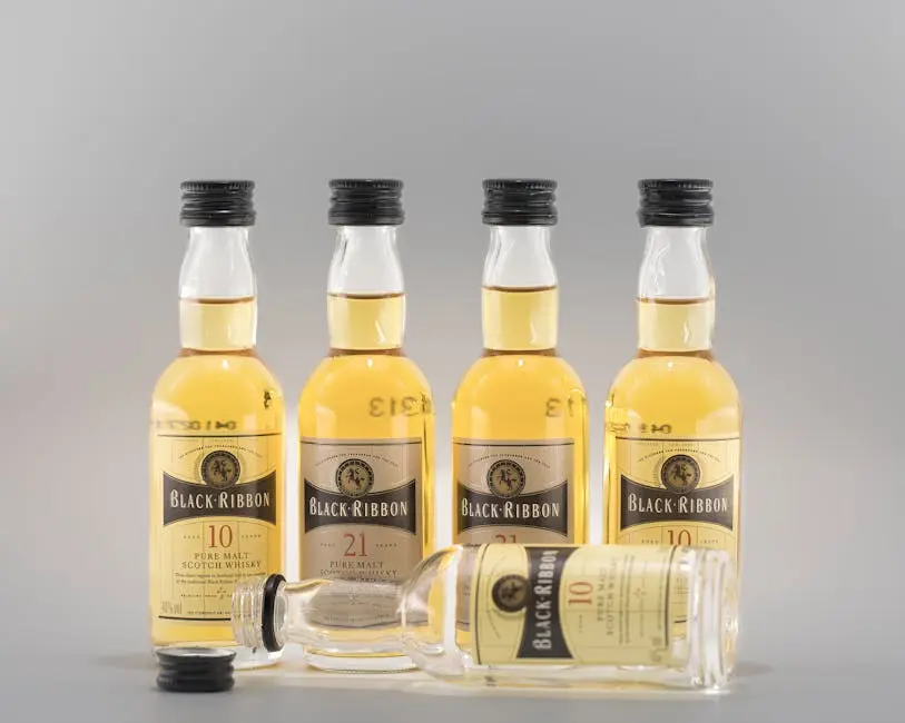 Five Black Ribbon whiskey bottles with a gray background, ideal for product advertisements.