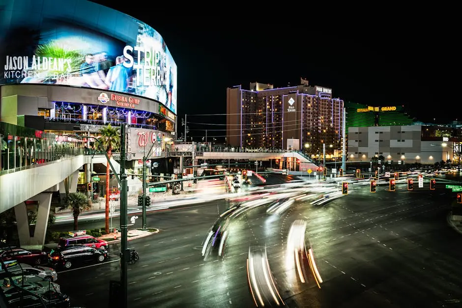Dynamic night scene on the Las Vegas Strip featuring vibrant lights and busy intersections.