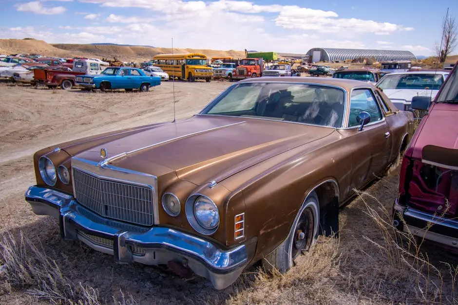 Explore a collection of vintage cars in a rustic junkyard, showcasing automotive history.