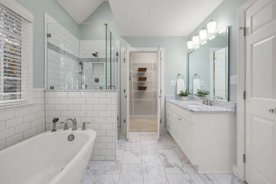 Elegant bathroom with white marble, glass shower, and bright lighting. Perfect for luxury home decor inspiration.