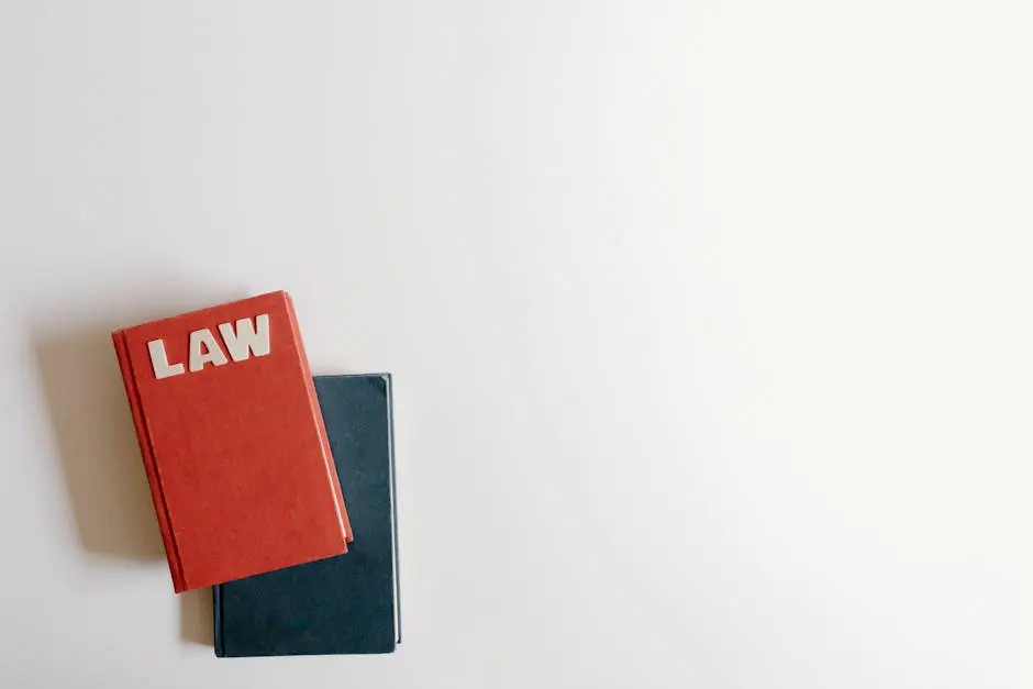 Flat lay of a red law book and a blue book on a white background, perfect for legal themes.