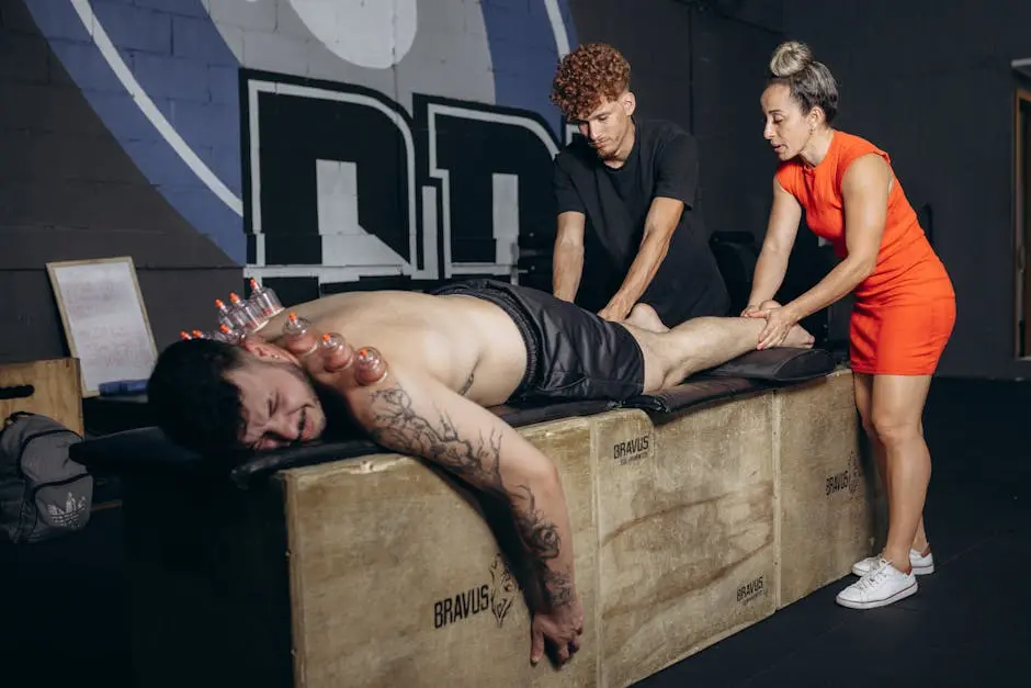 Athlete receiving cupping therapy and massage for recovery in a gym setting.