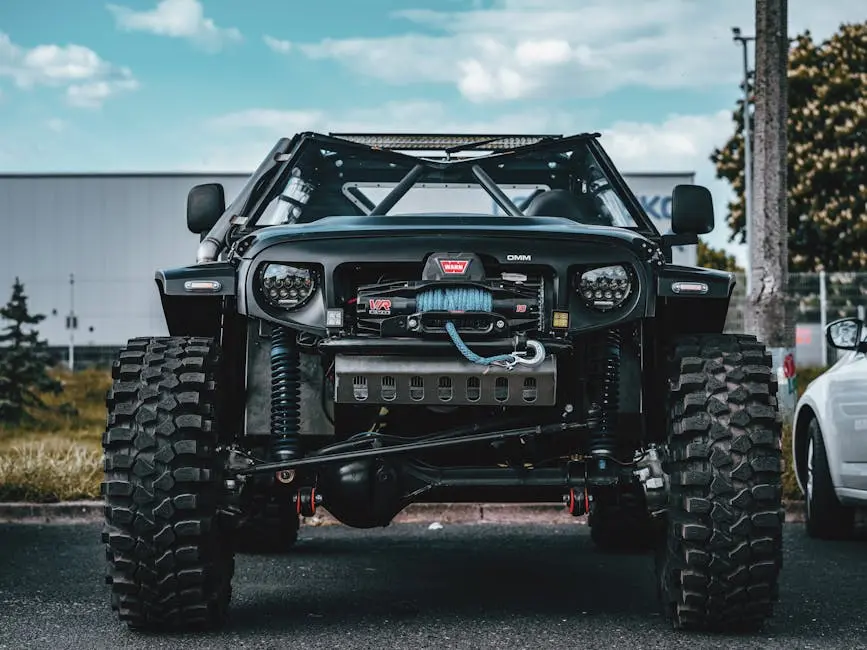 Close-up of a rugged off-road vehicle with a prominent tow rope, showcasing its robust build.