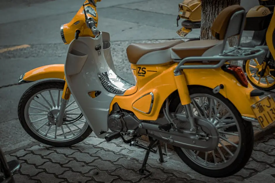 A vibrant yellow scooter parked on a city street, showcasing retro style and urban commuting.