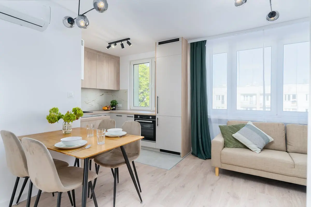 Bright kitchen with dining area in Scandinavian style, featuring minimalist design.