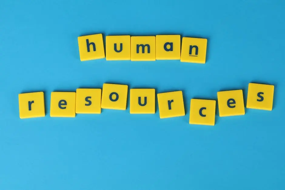Yellow tiles spelling &lsquo;human resources&rsquo; on a blue background, ideal for HR or business concepts.