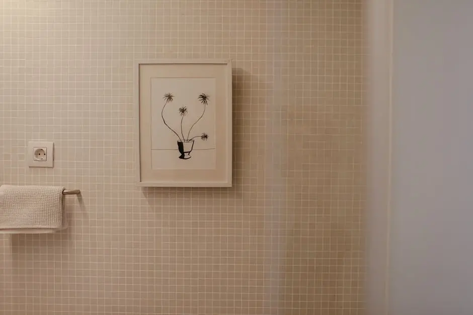 A modern bathroom featuring a framed plant illustration on tiled wall, perfect for interior inspiration.