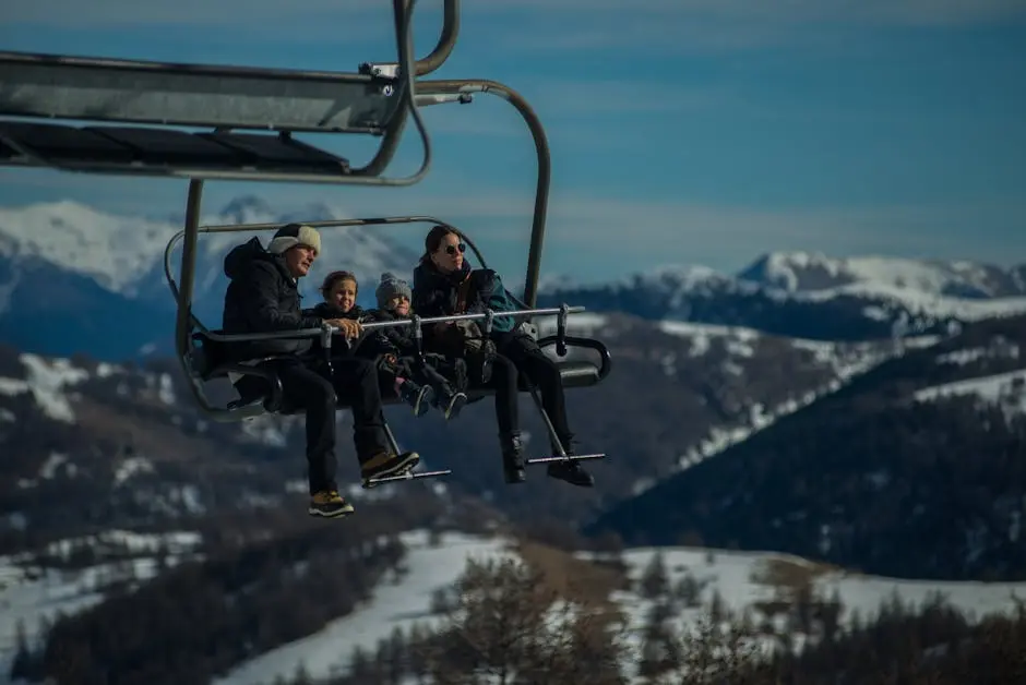 Family having fun on a ski lift with snow-covered mountains in the background during a sunny winter day.