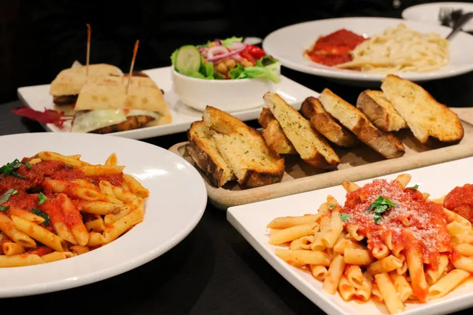 A vibrant display of Italian dishes with pasta, salad, and garlic bread in a Montreal restaurant setting.