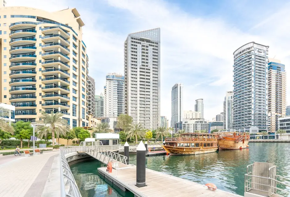 Stunning view of Dubai Marina with luxury buildings, wooden boats, and a calm waterfront.