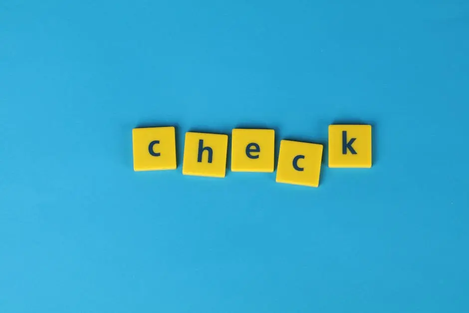 Yellow letter tiles spelling ‘check’ on a vibrant blue background, conveying approval or verification.