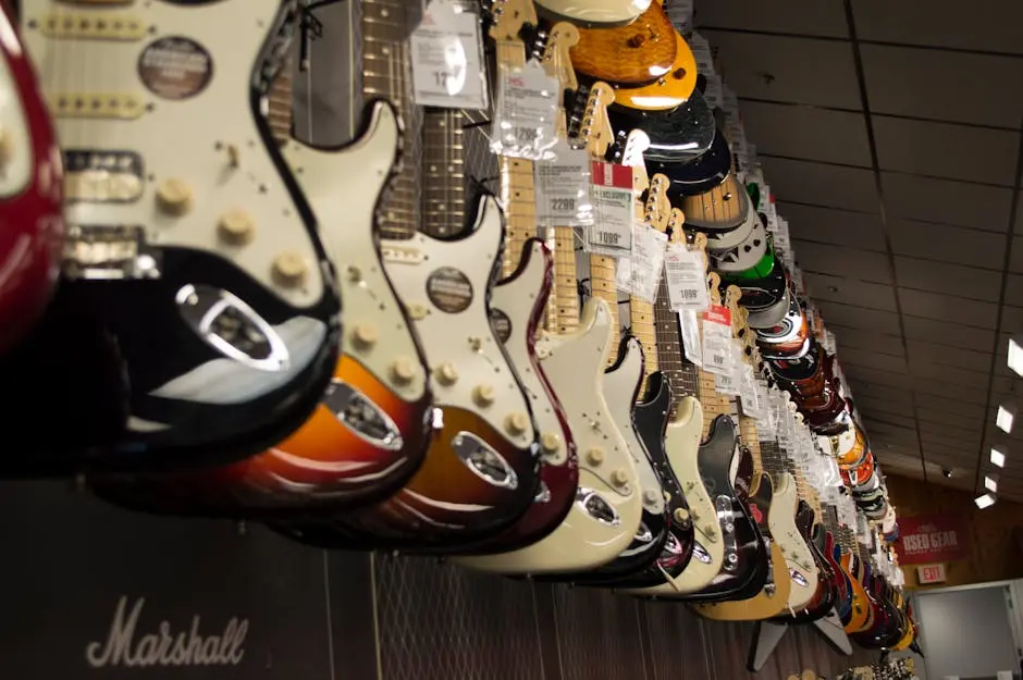 Row of colorful electric guitars hanging in a music store, showcasing diverse models and prices.