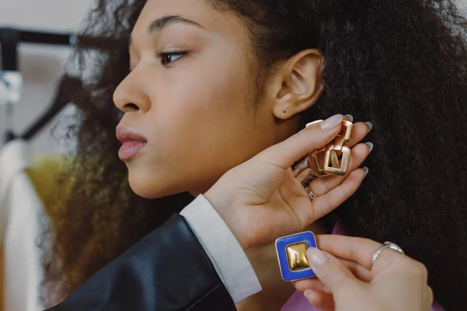 Close-up of a woman trying on luxury earrings in a fashion store setting.