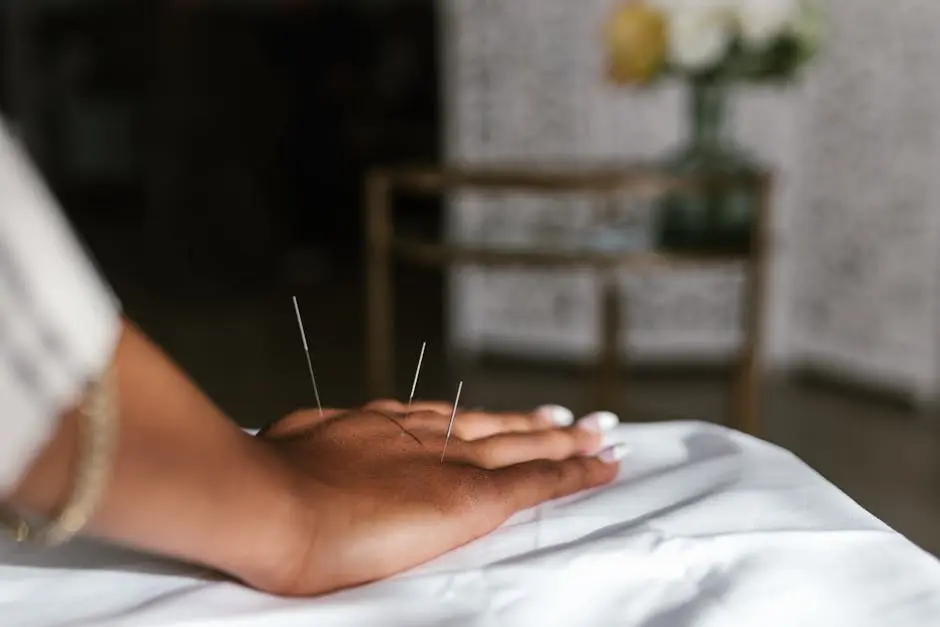 Close-up of acupuncture needles in a hand during treatment, promoting relaxation.