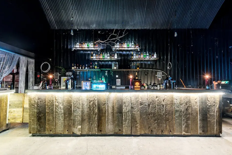 A stylish and modern bar interior featuring a rustic wooden counter and ambient lighting, creating a unique nightlife atmosphere.