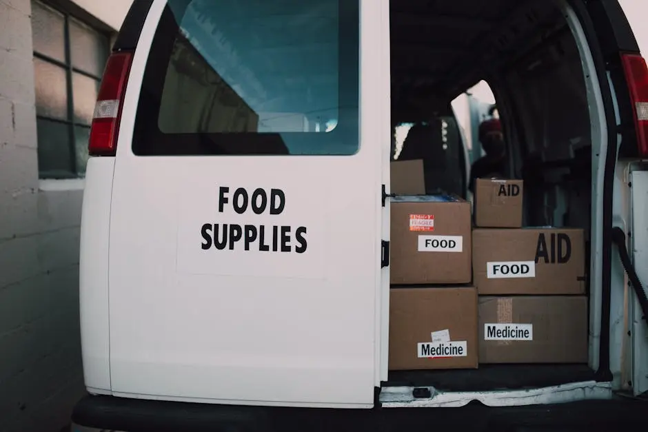 Van loaded with aid supplies and food boxes for charity distribution.