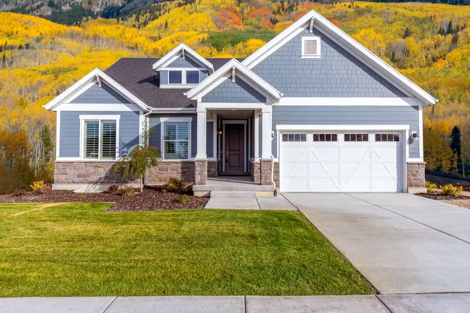 Beautiful suburban house with vibrant autumn foliage backdrop.