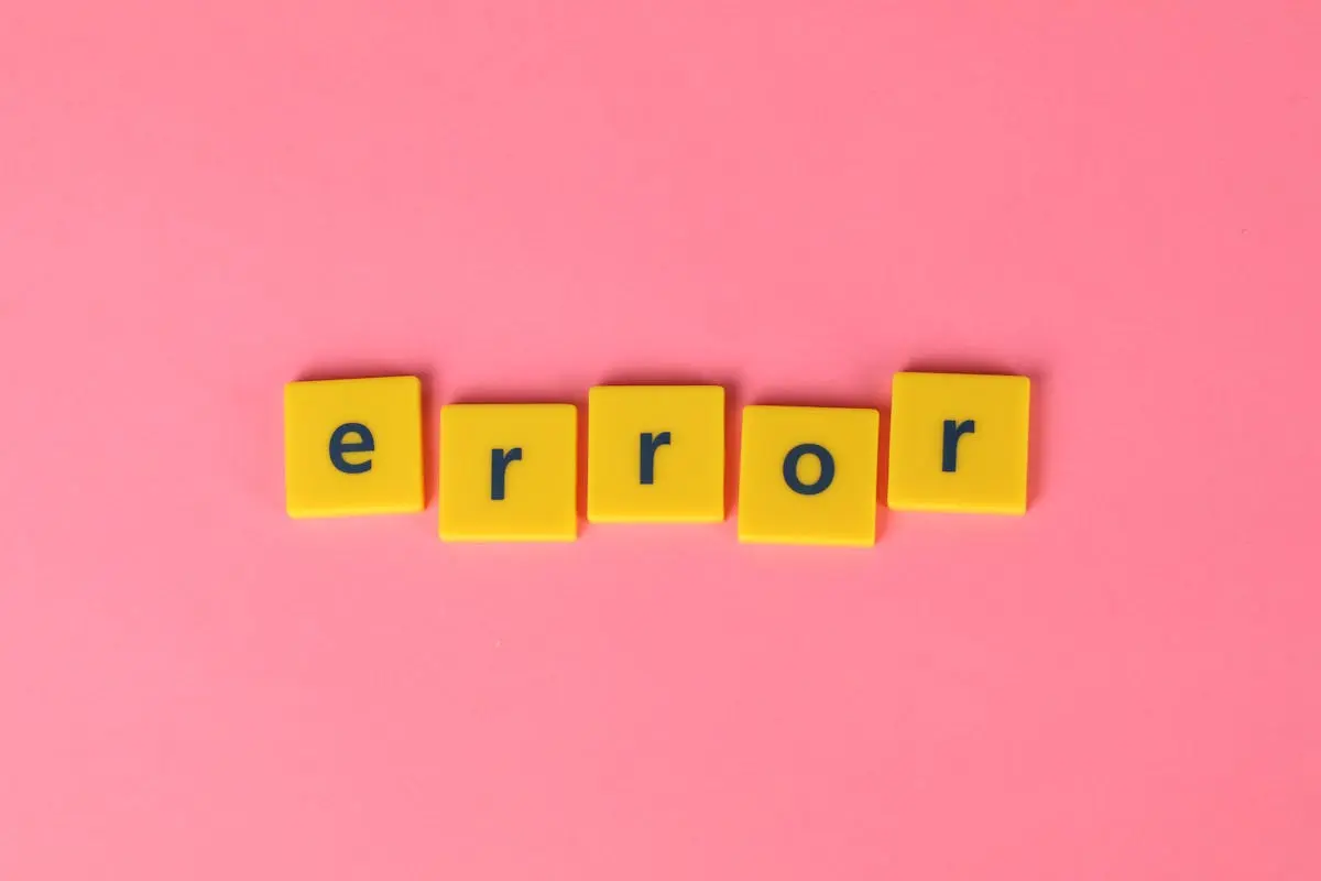 Yellow block letters spelling ‘error’ on a vibrant pink background, capturing a playful message.