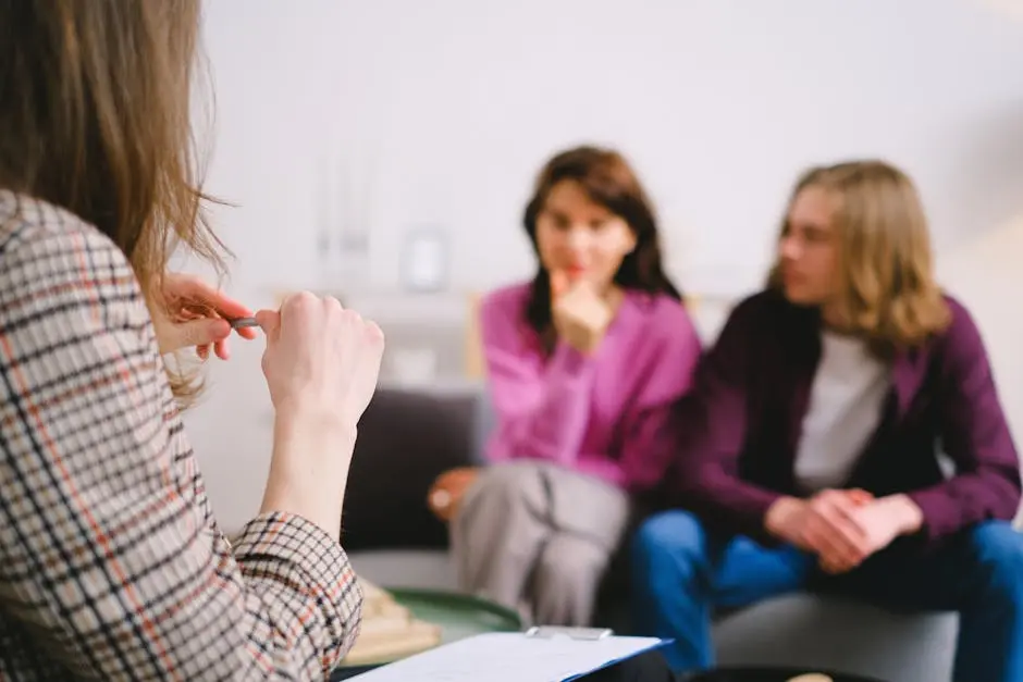 A couple in therapy, guided by a professional therapist in a calm setting.