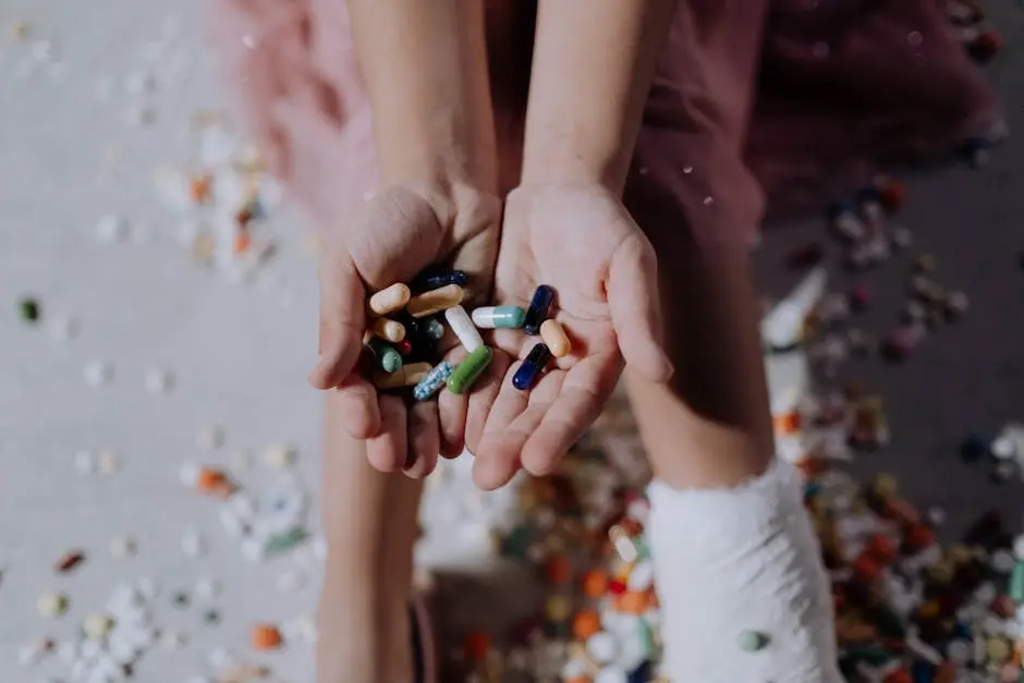 Close-up of a child holding pills with an injured leg in a cast, symbolizing health and recovery.