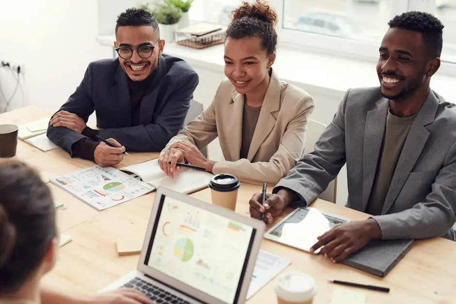 A diverse team of professionals having a meeting in a modern office setting, discussing business acquisitions.