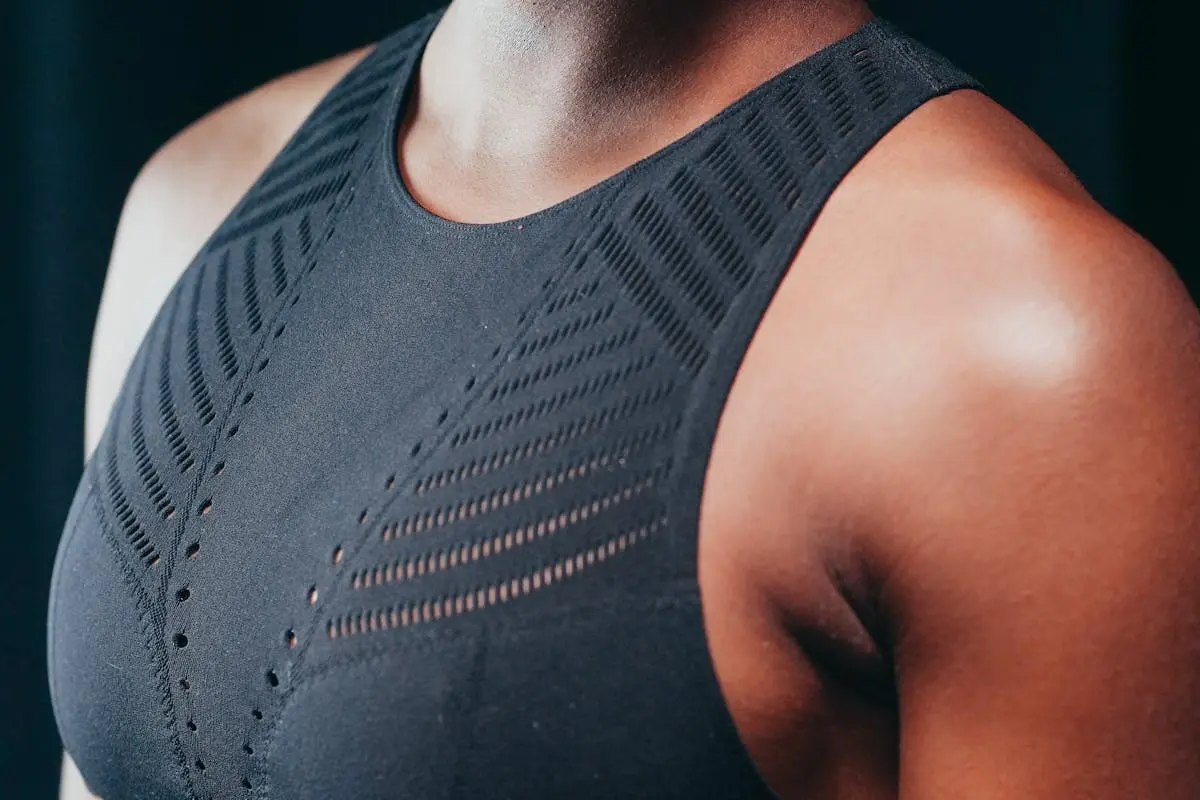 Detailed close-up of a person wearing a black sports bra, focusing on the texture and design.