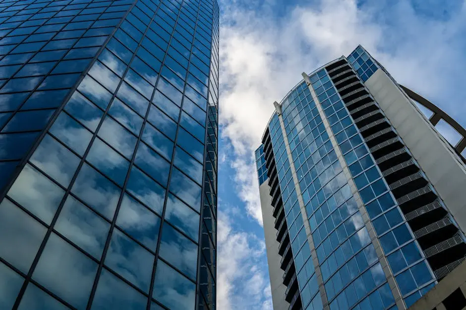 Low angle view of modern skyscrapers with glass windows reflecting clouds in Orlando, Florida.